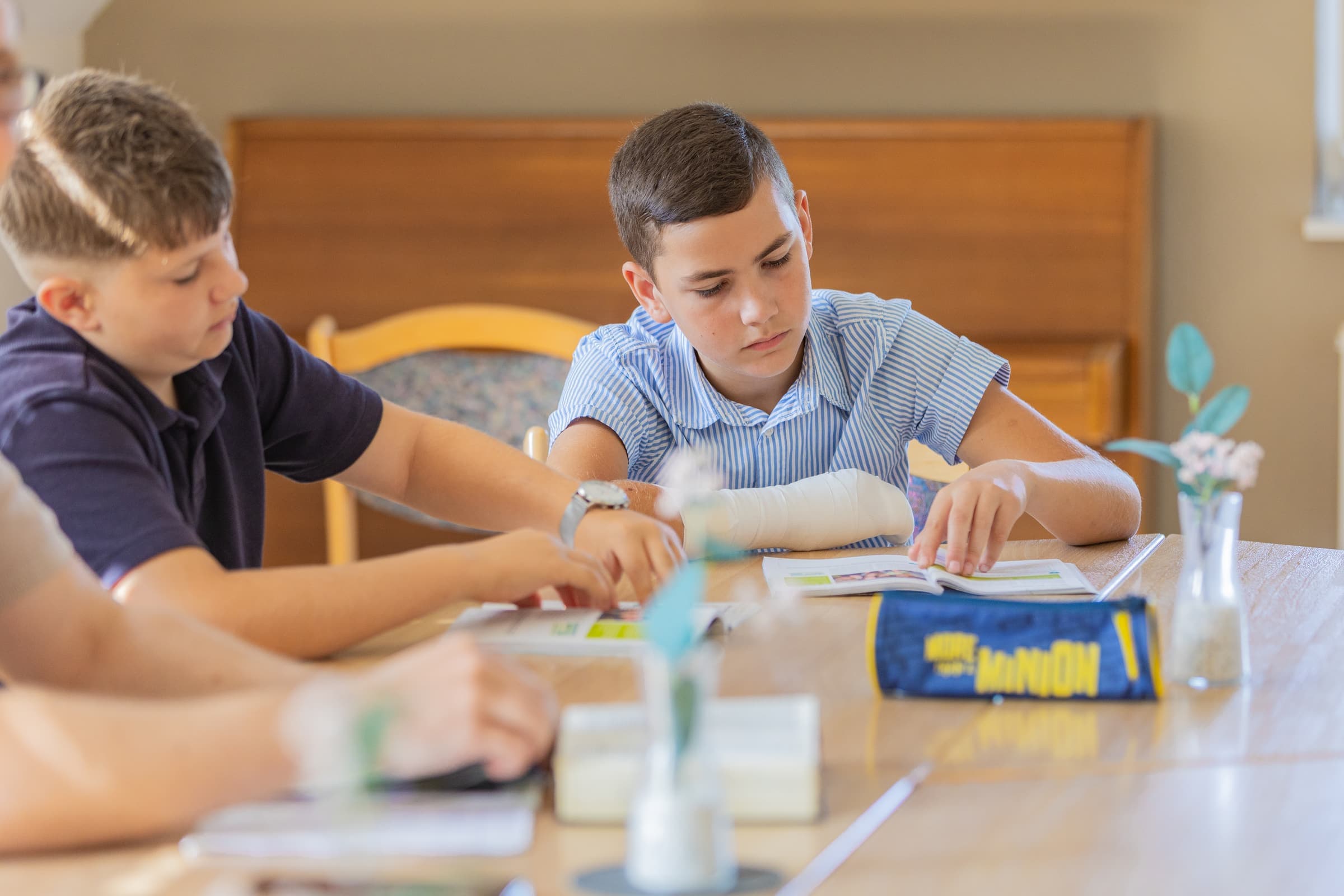 Zwei Jugendliche lesen gemeinsam in ihren Arbeitsheften